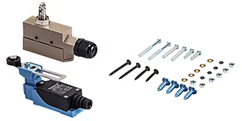 Componentes eléctricos metálicos y tornillos aislados sobre fondo blanco.