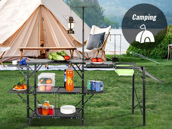camping setup with a VEVOR camping kitchen table, stocked with food and supplies, in front of a tent.
