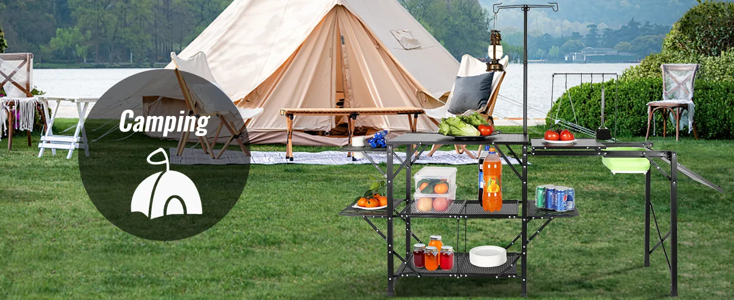 camping setup with a VEVOR camping kitchen table, stocked with food and supplies, in front of a tent.