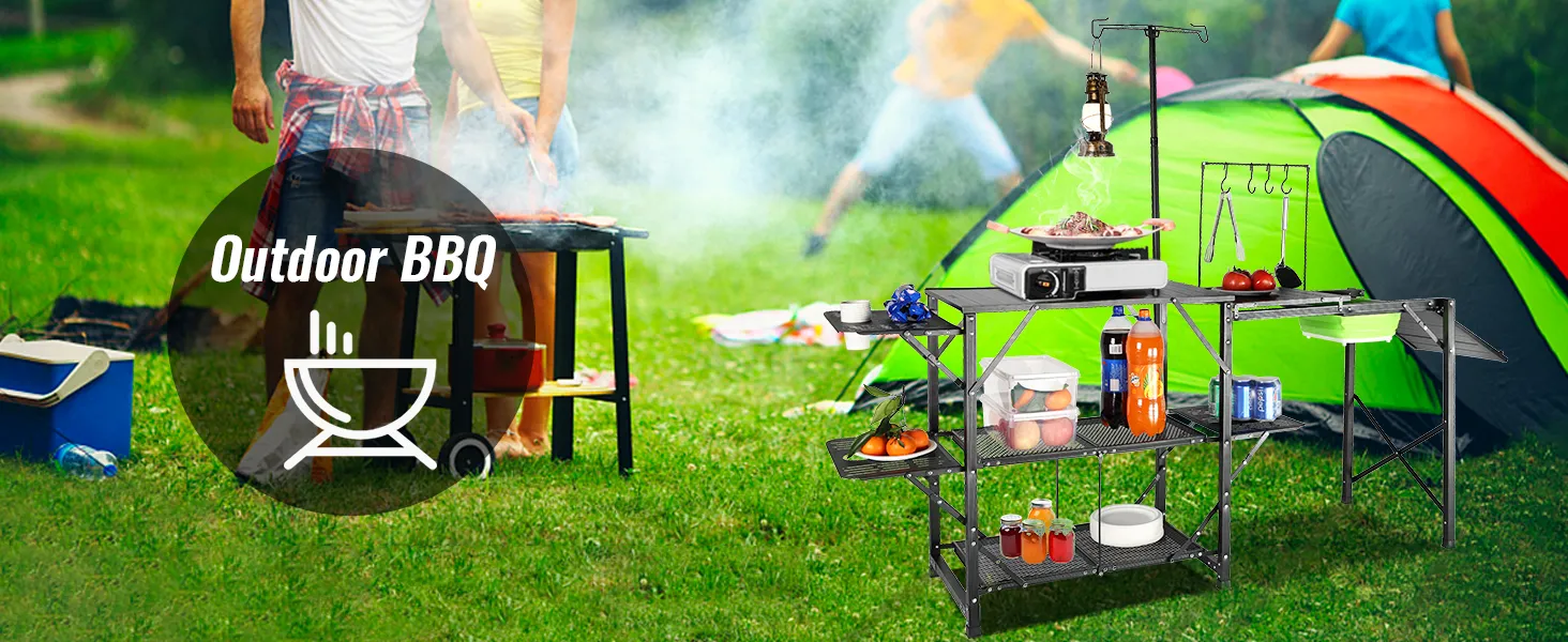 VEVOR camping kitchen table at an outdoor bbq with tents and cooking setup in a grassy park.