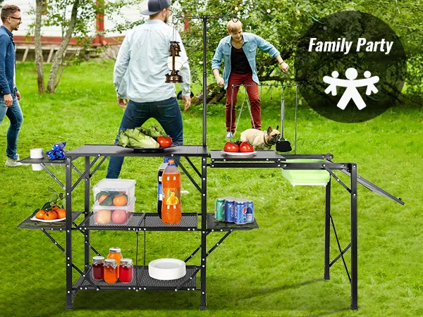 family enjoying outdoor activities with VEVOR camping kitchen table set up in a scenic meadow.
