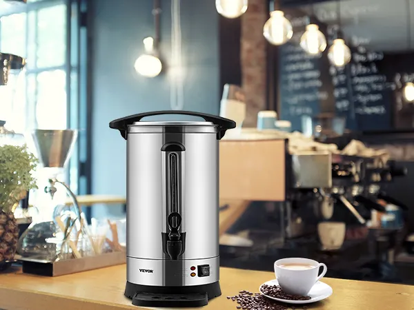 Cafetera VEVOR en un acogedor entorno de cafetería con una taza de café, máquina de café expreso y plantas decorativas.