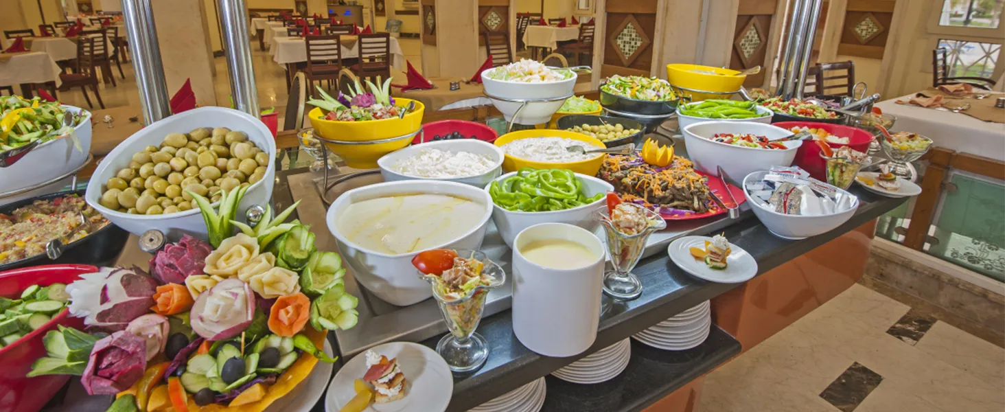 buffet spread with olives, salads, soups, and garnishes displayed on tables in a restaurant using a VEVOR commercial food warmer.