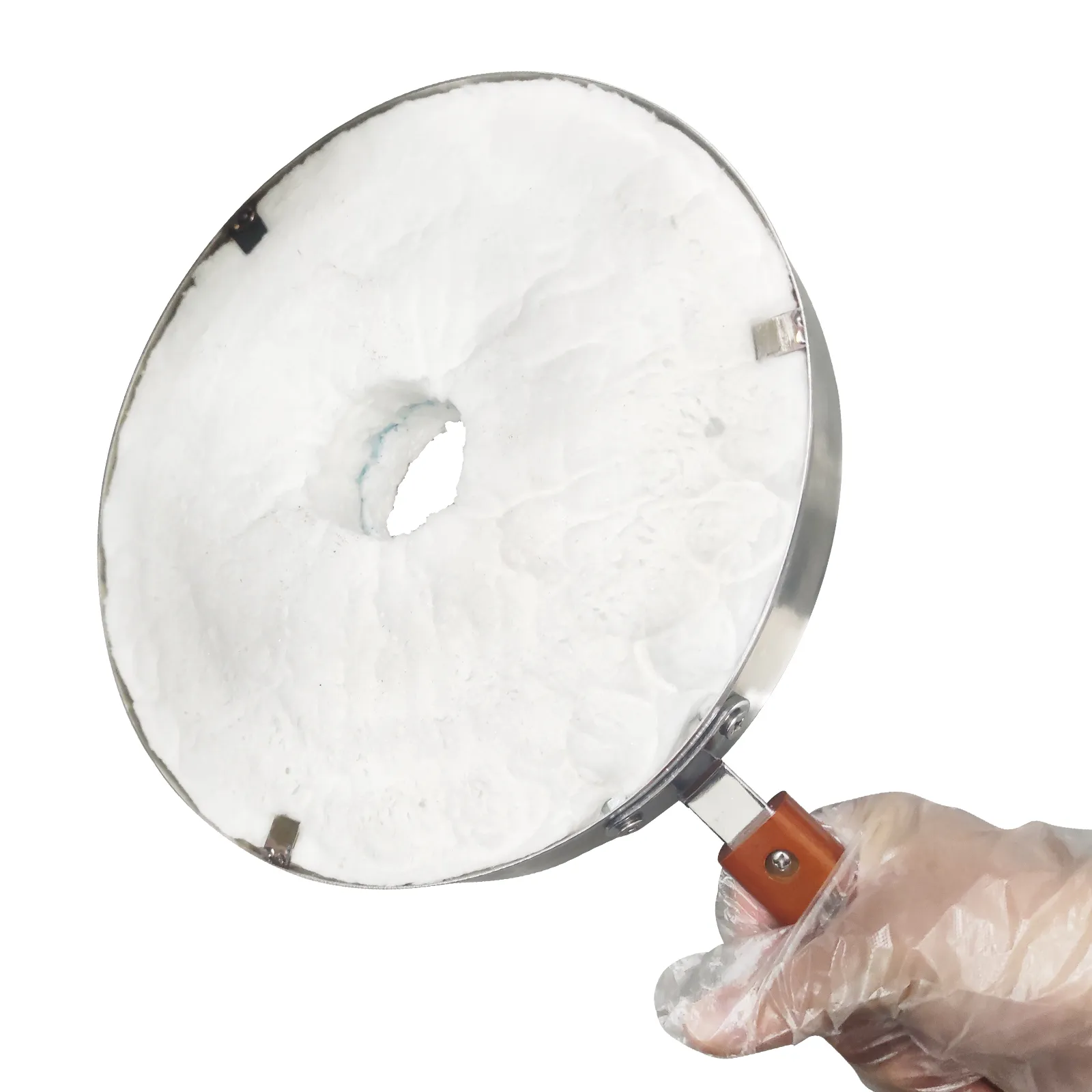 hand holding a circular component of a VEVOR propane smelting furnace with a white insulated surface.