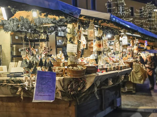 festive market stall with decorations, wooden products, and lighting creates a cozy holiday ambiance.