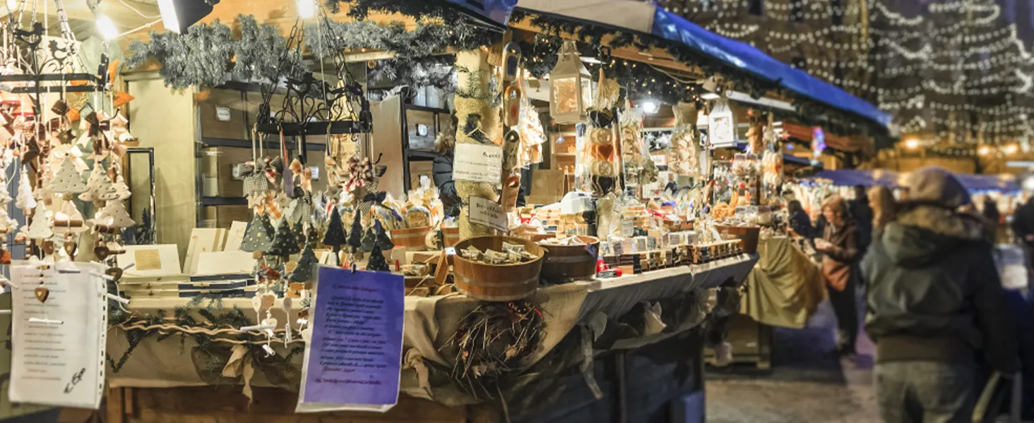 festive market stall with decorations, wooden products, and lighting creates a cozy holiday ambiance.