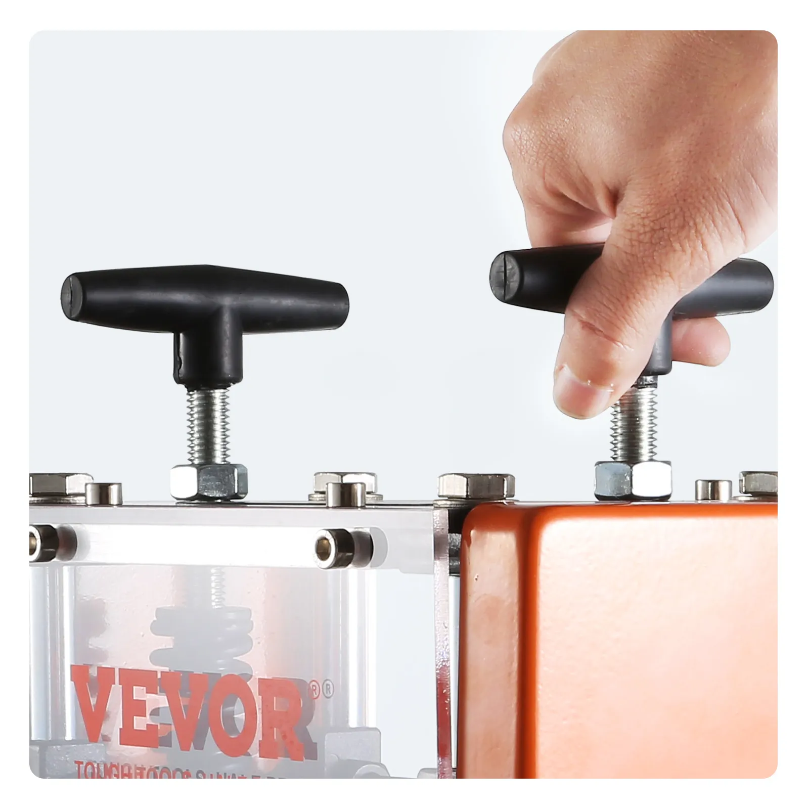 hand operating VEVOR wire stripping machine with black handle and orange casing