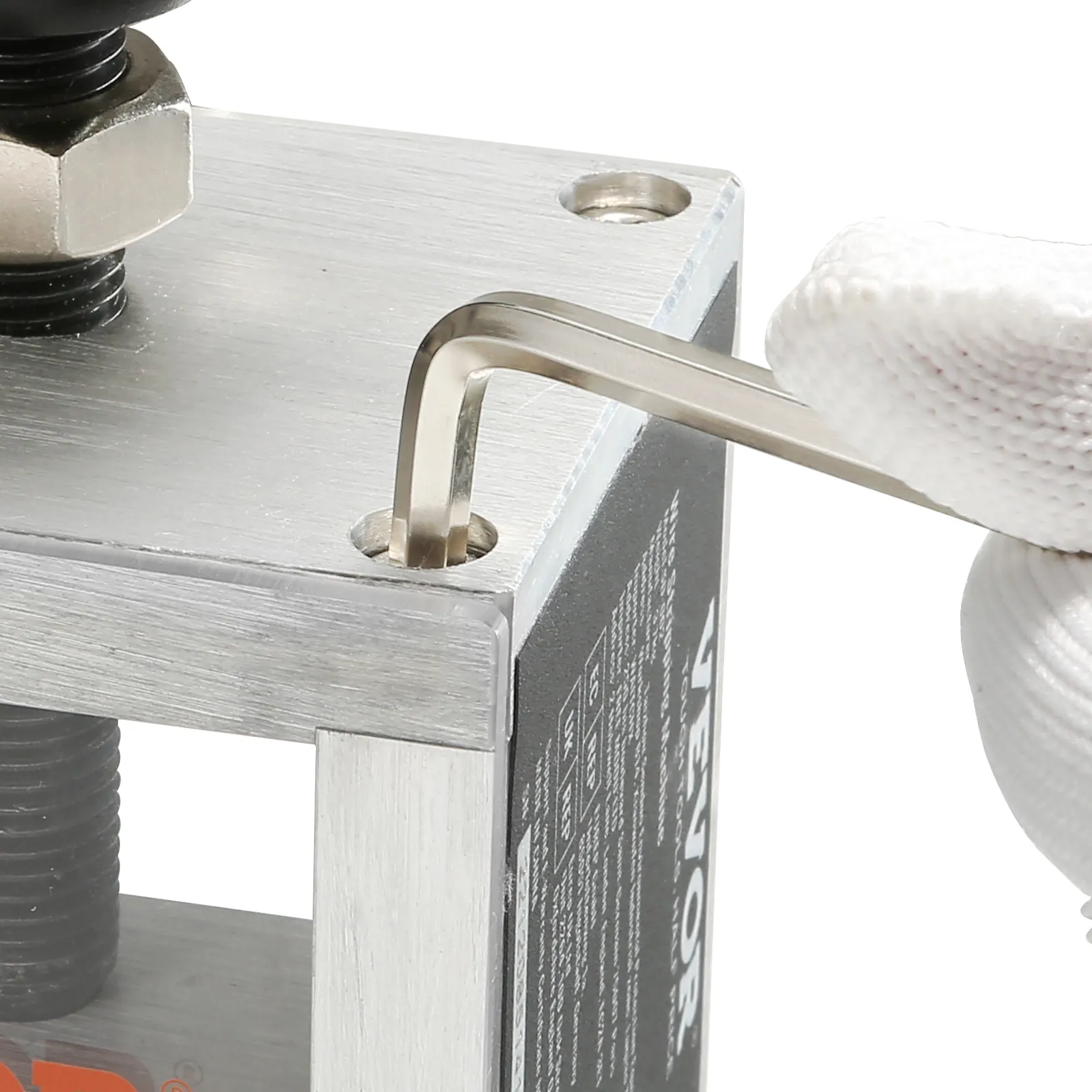 adjusting screws on the VEVOR wire stripping machine with an allen wrench while wearing white gloves.