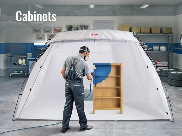VEVOR portable paint booth in garage, showing person spray painting a wooden shelf unit blue.
