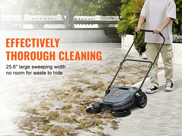 man using VEVOR floor sweeper to clear leaves on a large concrete area with 25.6" sweeping width.