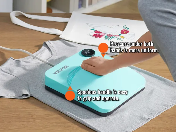 VEVOR heat press machine with easy-grip handle being used to press designs on a tote bag and t-shirt.