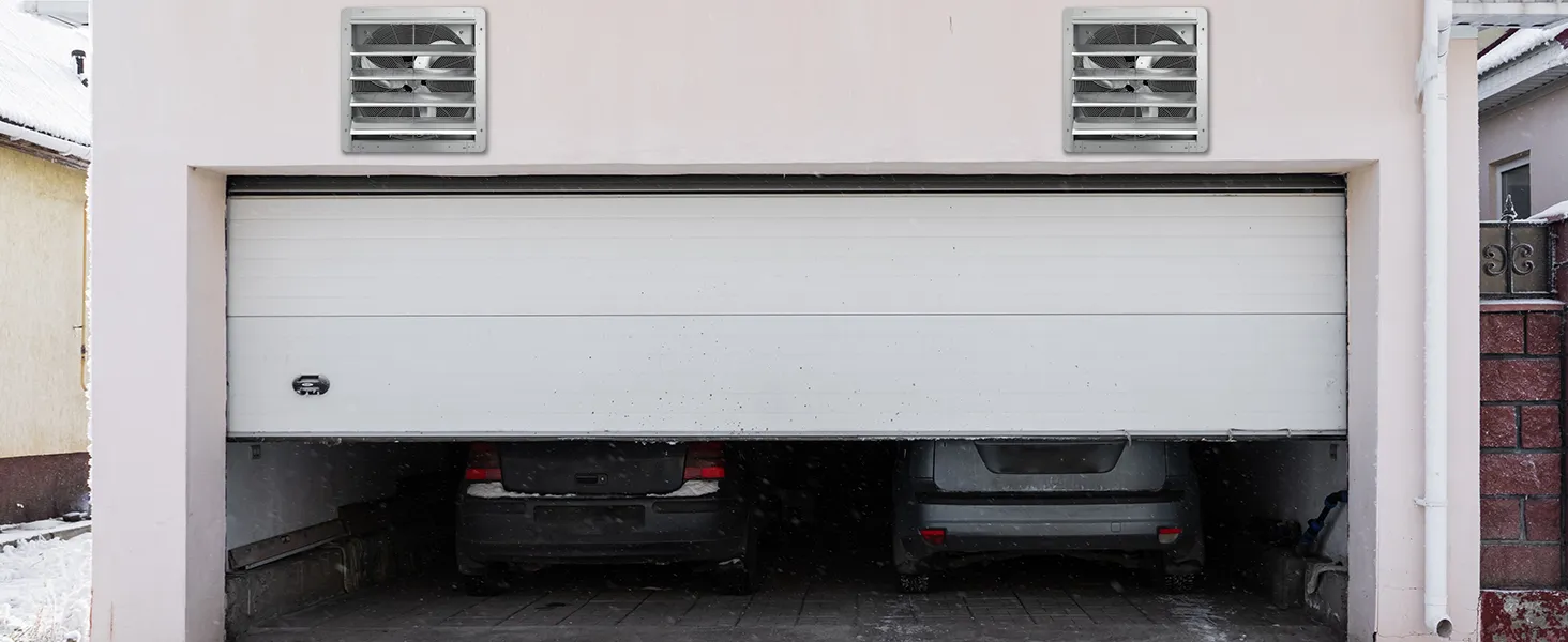 garage with two cars and two VEVOR shutter exhaust fans installed on the upper wall.