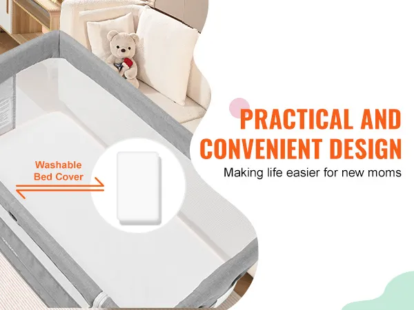 Cuna de bebé VEVOR con funda de cama lavable, gris y blanca junto al sofá, diseño práctico para mamás.