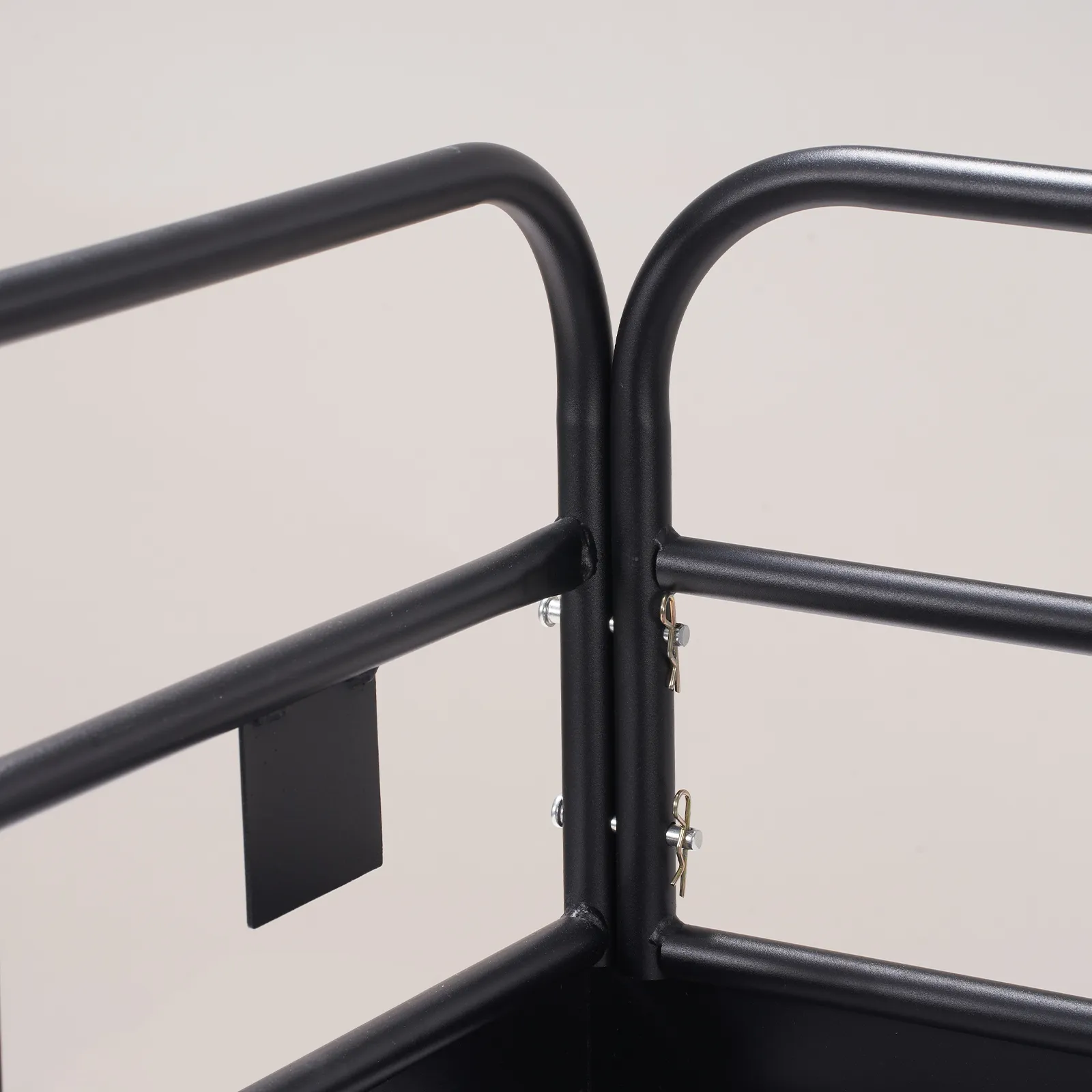 close-up of the VEVOR trail hitch cargo carrier's black metal frame with secure bolts and a minimalist design.