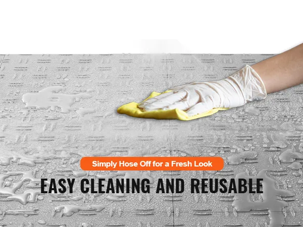 VEVOR garage tiles being hosed off for easy cleaning, showcasing reuse and maintenance benefits.