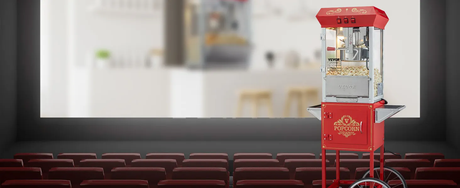 Máquina para hacer palomitas de maíz VEVOR de color rojo sobre ruedas en un teatro vacío con asientos rojos y una pantalla de fondo.