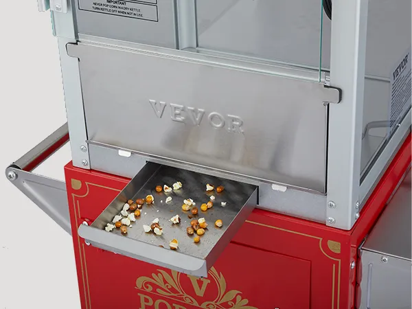Máquina para hacer palomitas de maíz VEVOR con cajón de acero inoxidable y base roja, que muestra palomitas de maíz esparcidas.