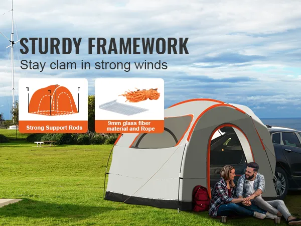 VEVOR suv camping tent set up by the ocean, showcasing sturdy framework with support rods and rope.