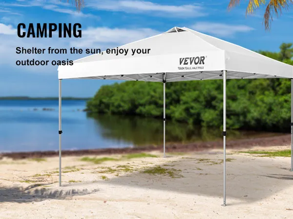 VEVOR pop up canopy tent on a sandy beach with palm trees and a serene lake in the background.