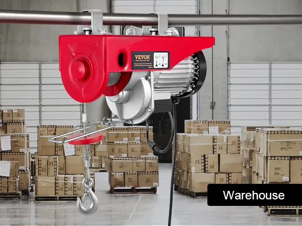 VEVOR 2200 lbs wireless attic lift in a warehouse with stacked boxes and industrial shelves.