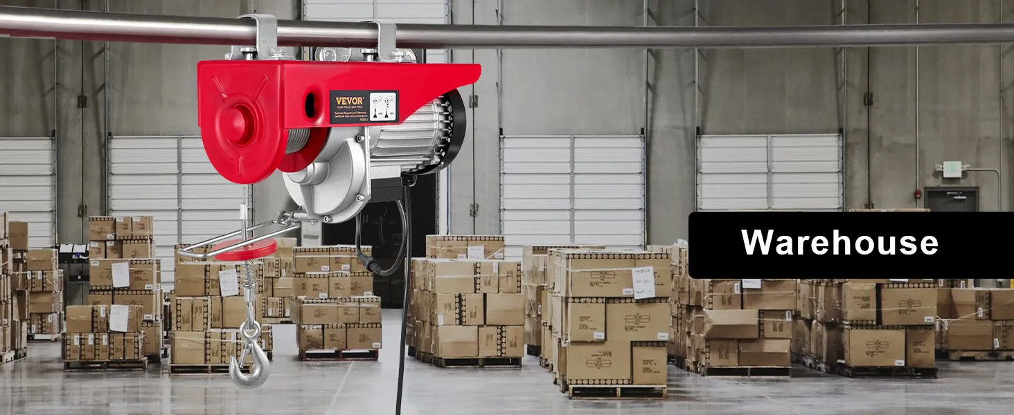 VEVOR 2200 lbs wireless attic lift in a warehouse with stacked boxes and industrial shelves.