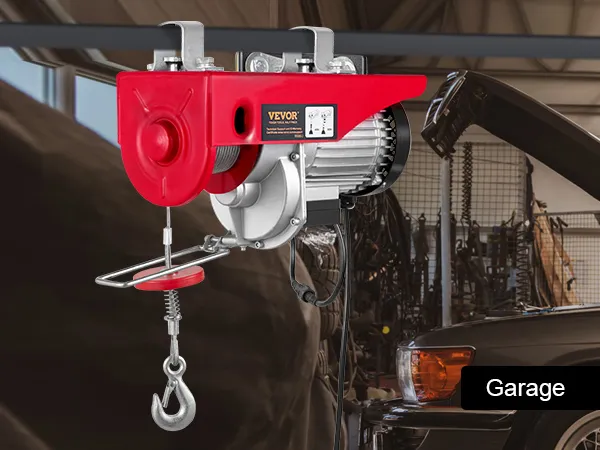 VEVOR electric hoist mounted in a garage with a car and tools in the background.