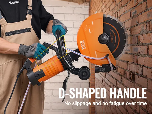person using VEVOR electric concrete saw with orange d-shaped handle against a brick wall.