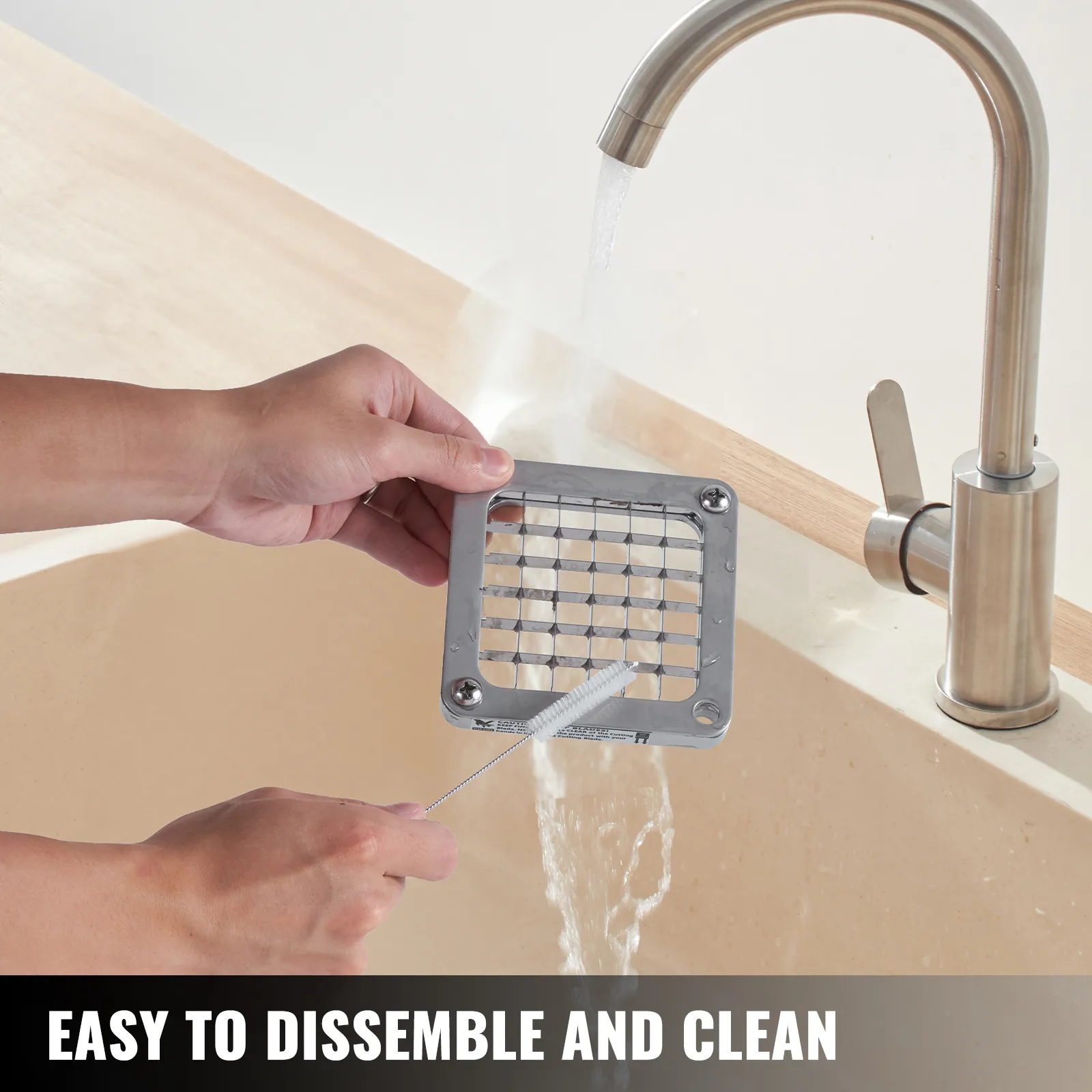 cleaning grid of VEVOR electric french fry cutter under faucet, showcasing easy disassembly.