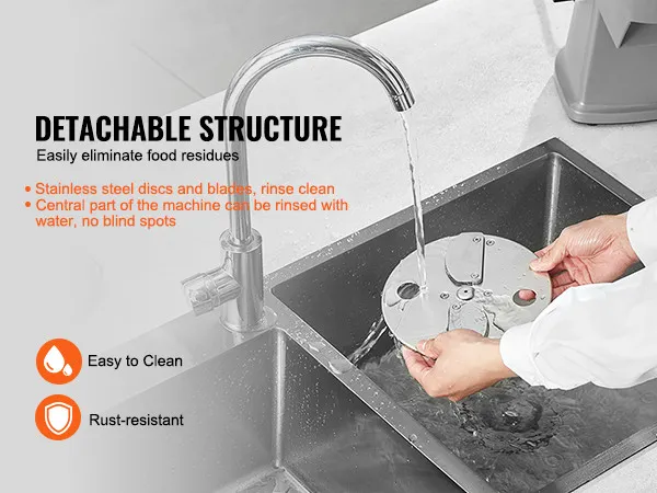 detachable VEVOR electric vegetable slicer disc being rinsed in a sink. easy to clean and rust-resistant.