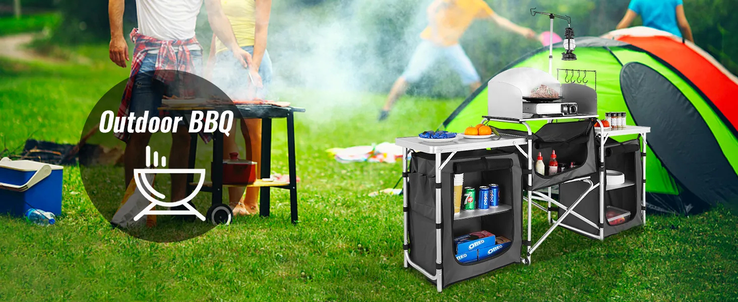 VEVOR camping kitchen table at an outdoor bbq with people grilling near a tent setup.