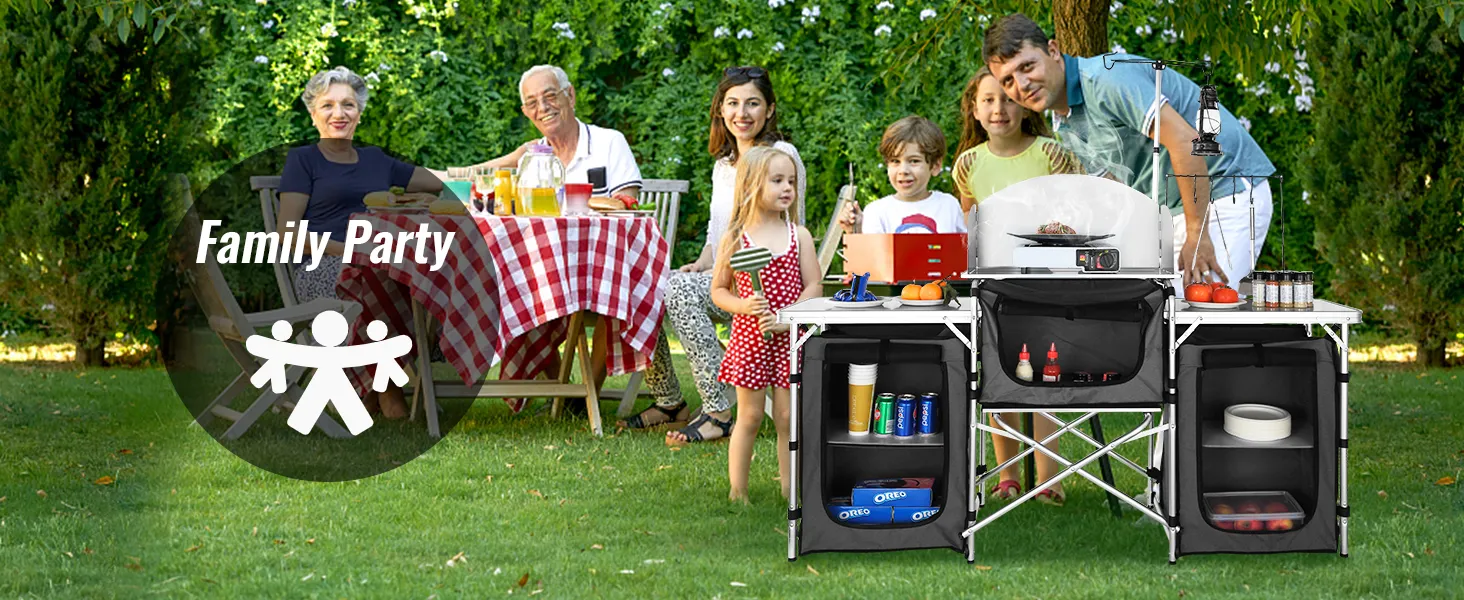 family enjoying outdoor meal with VEVOR camping kitchen table, grill, and food supplies on green lawn.