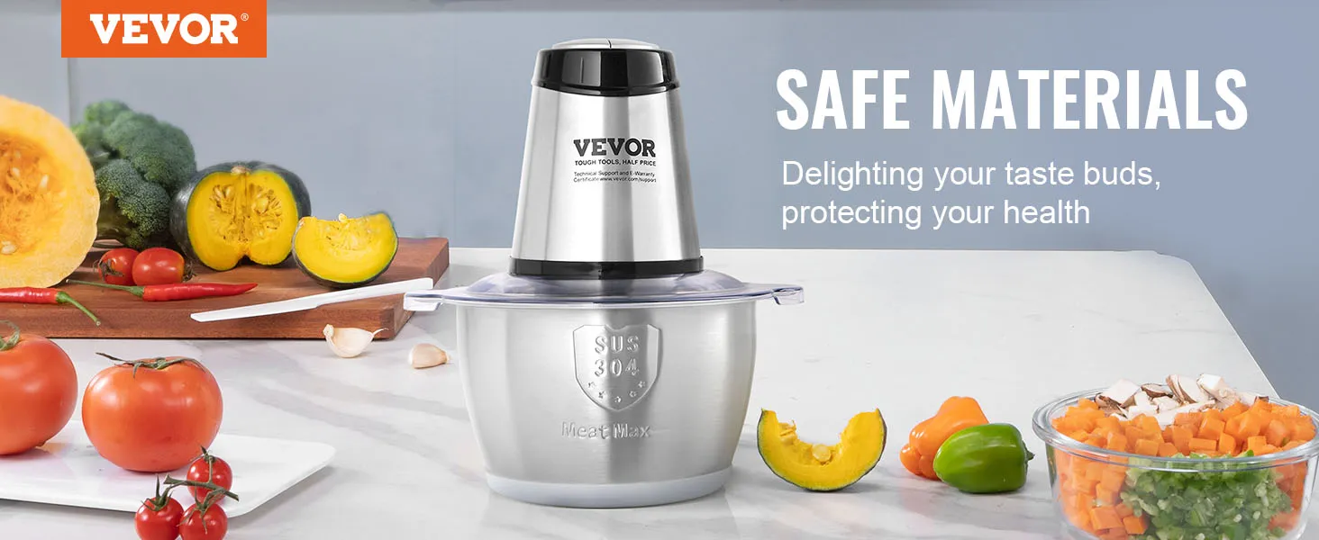Picadora de carne eléctrica VEVOR en acero inoxidable con verduras frescas sobre la encimera de la cocina.