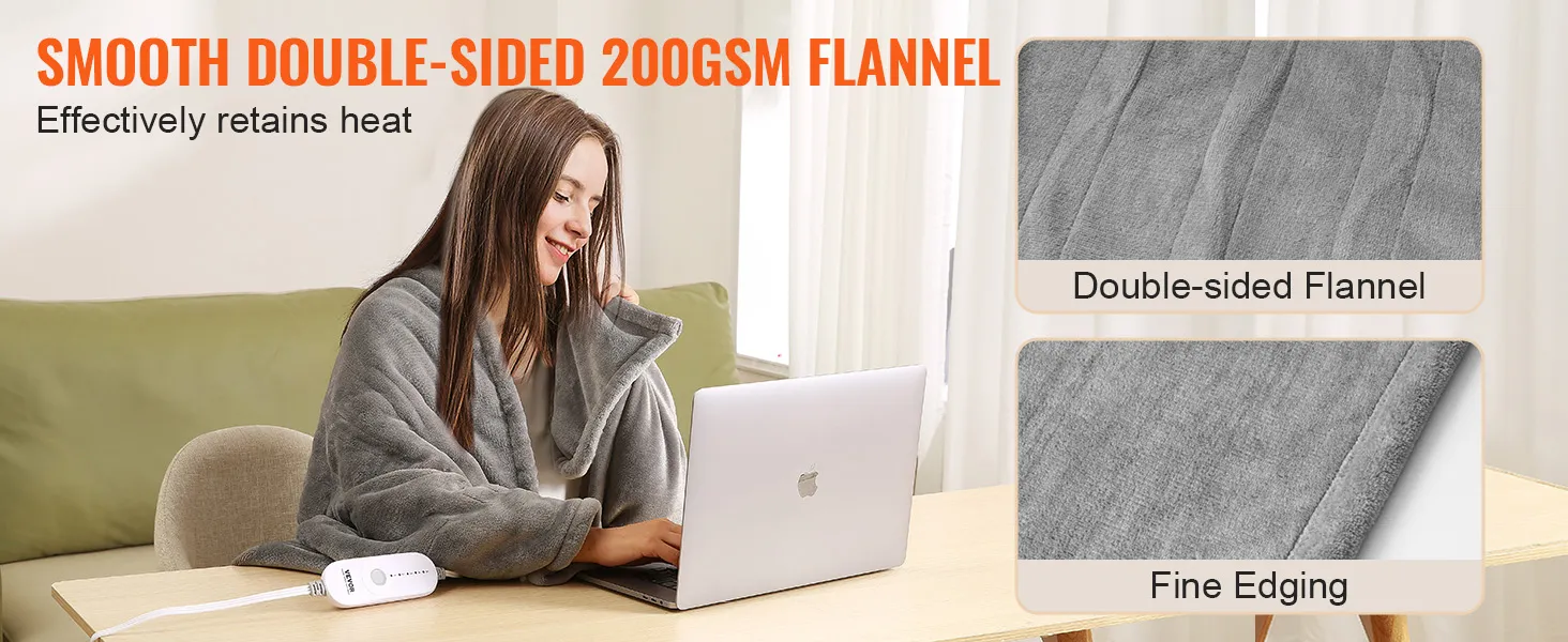 person using VEVOR heated blanket with double-sided 200gsm flannel and fine edging while working on a laptop.