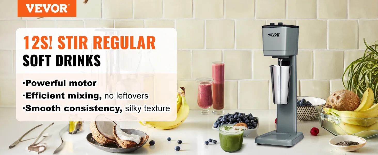 Máquina para hacer batidos VEVOR en la encimera de la cocina con plátanos, bayas y bebidas.