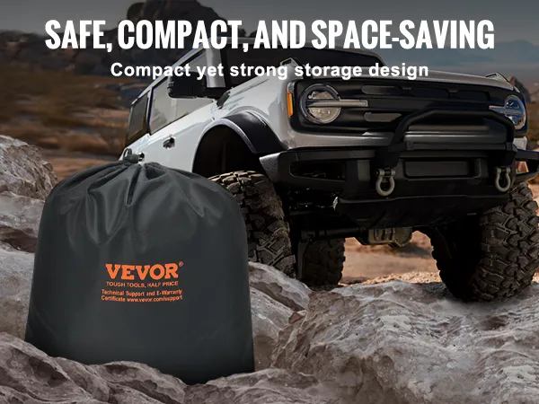 VEVOR tow strap in a compact black storage bag next to an off-road vehicle on rocky terrain.