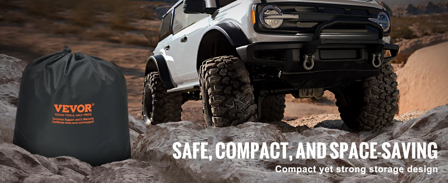 VEVOR tow strap in a compact black storage bag next to an off-road vehicle on rocky terrain.
