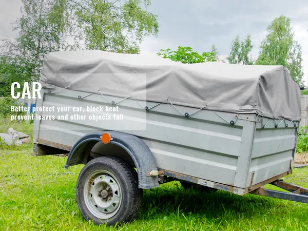 trailer with gray VEVOR waterproof tarp in a grassy area, protecting against weather elements.