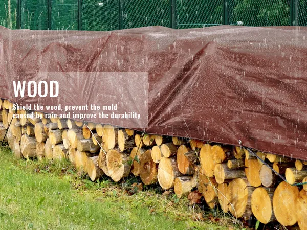 VEVOR waterproof tarp covering stacked wood, protecting it from rain beneath a vivid green fence.