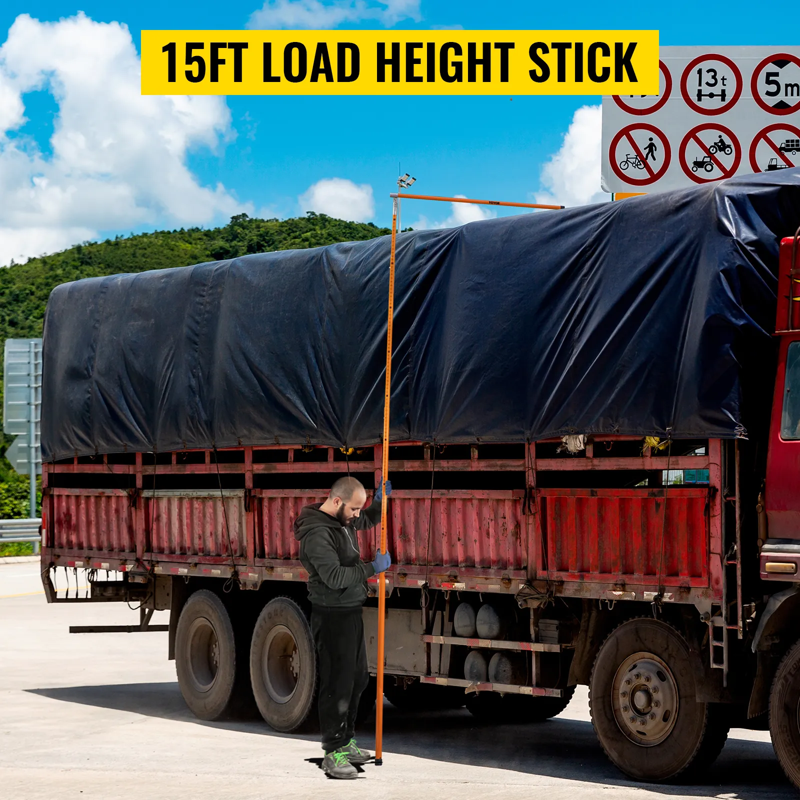 VEVOR truck height measuring stick being used next to a covered truck with safety signs in the background.
