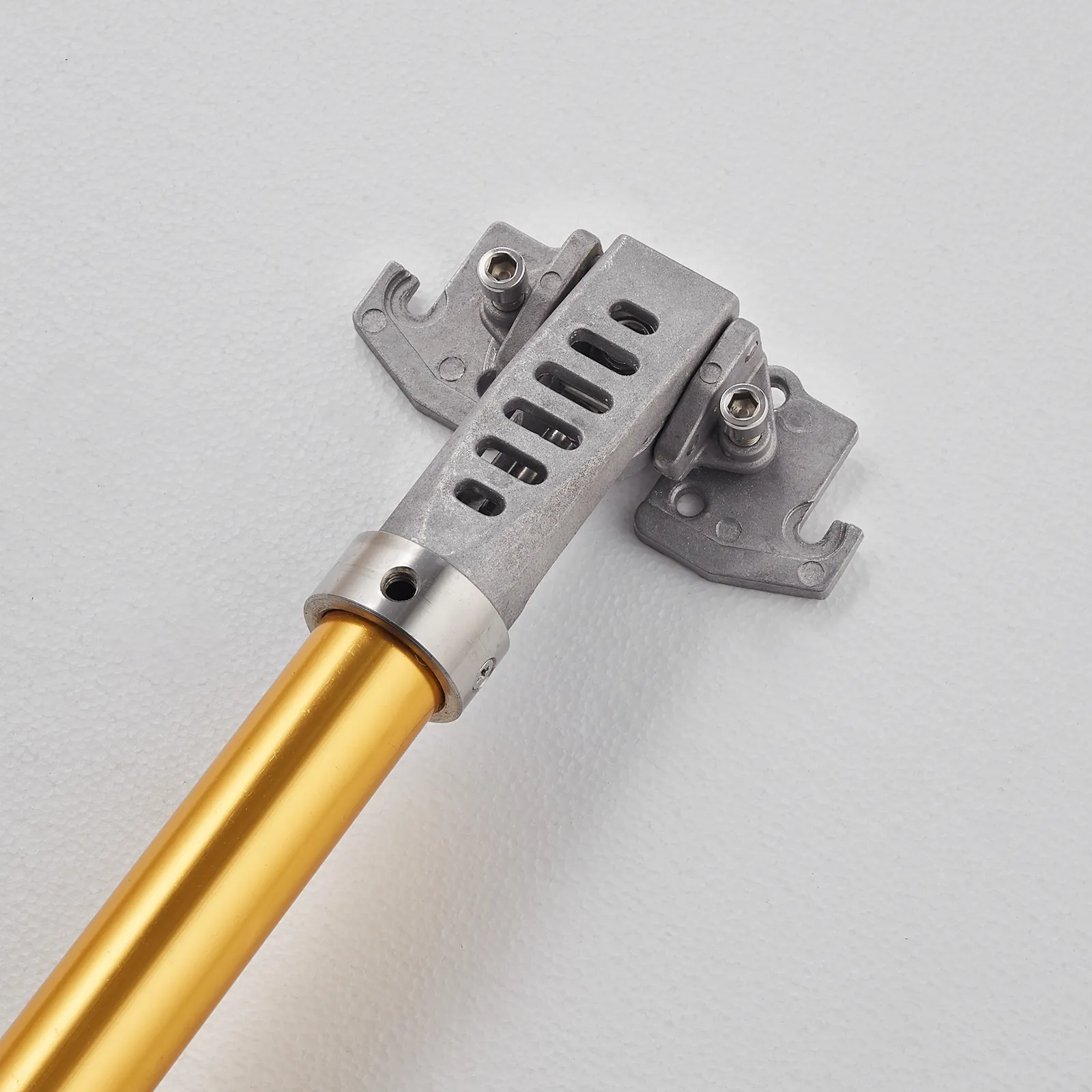 close-up of a golden VEVOR drywall flat box handle with a metallic joint against a white background.