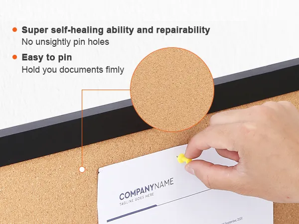 hand pinning a document to a VEVOR cork board with self-healing surface and black frame.