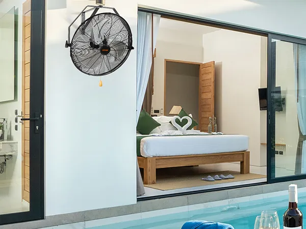 modern patio with VEVOR wall mount fan beside sliding doors, overlooking a luxurious pool and bedroom.