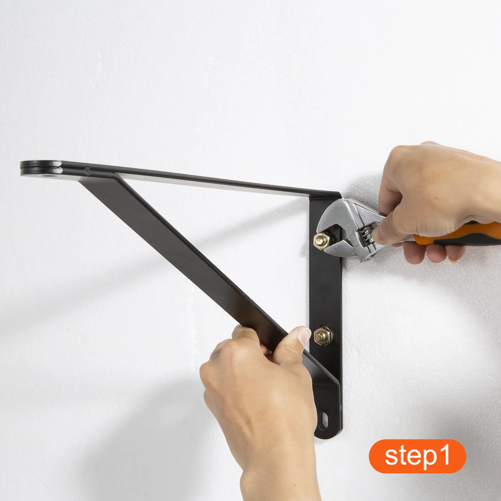 hand mounting VEVOR wall mount fan bracket on white wall with a wrench, labeled "step 1".