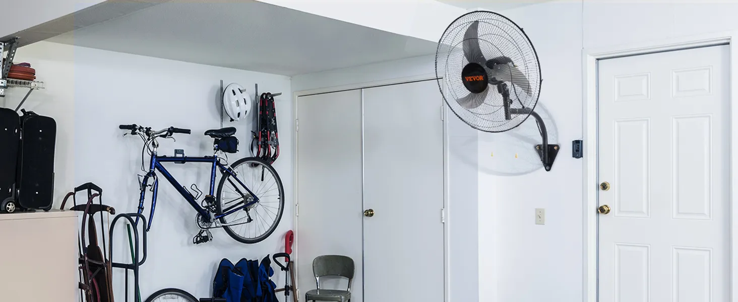 garage with VEVOR wall mount fan, bicycles, a metal chair, and storage units against a white wall.