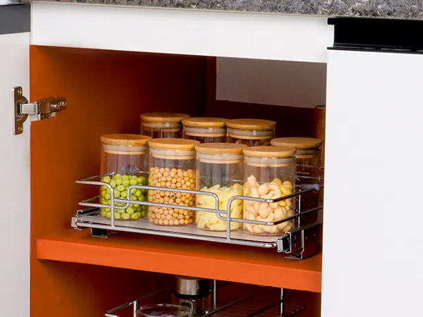 modern kitchen with a VEVOR pull out cabinet organizer holding various jars, granite countertop above.
