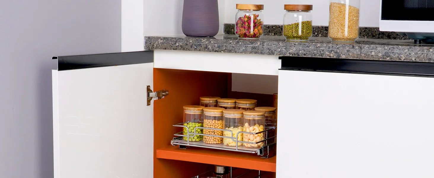 modern kitchen with a VEVOR pull out cabinet organizer holding various jars, granite countertop above.