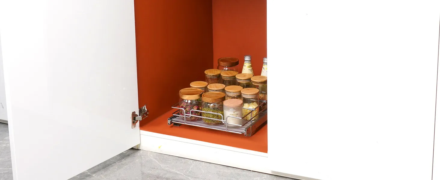 VEVOR pull out cabinet organizer with jars and bottles on an orange background inside a white cabinet.