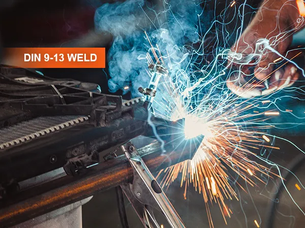 welding with sparks flying, showcasing a VEVOR welding helmet with din 9-13 weld settings visible.