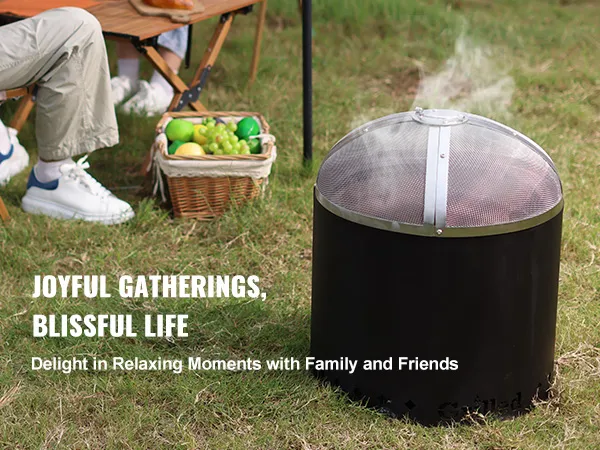outdoor scene with VEVOR fire pit spark screen, people enjoying picnic with fruit basket on grass.