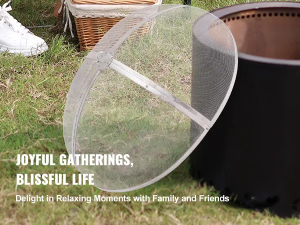 outdoor gathering with VEVOR fire pit screen, basket of fruits, and people relaxing on grass.